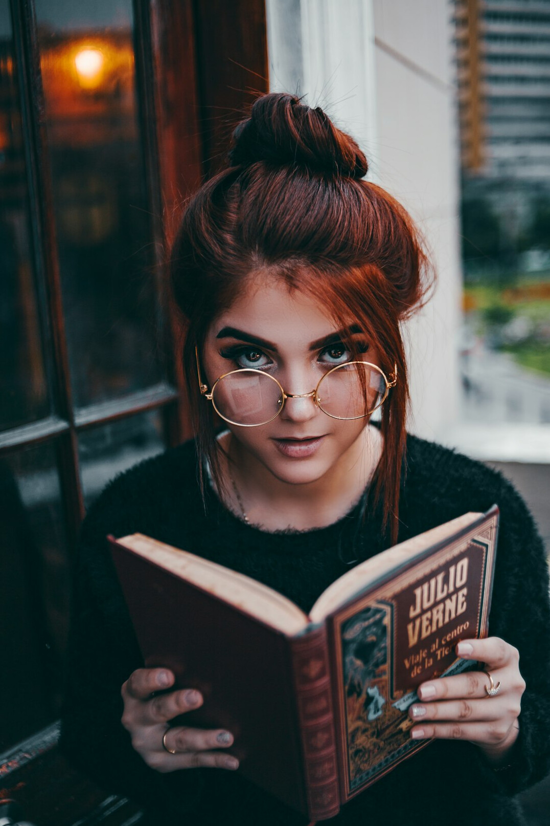 teen reading book about media